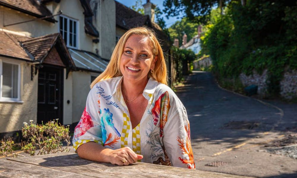 Josie Gibson smiling and sitting at a table outside